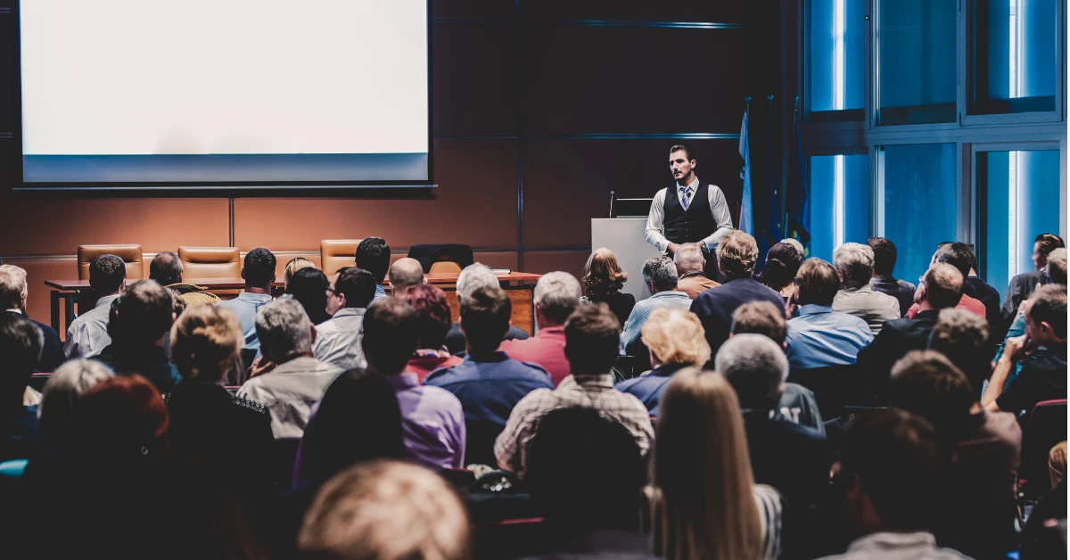 Speaker presenting to a live audience